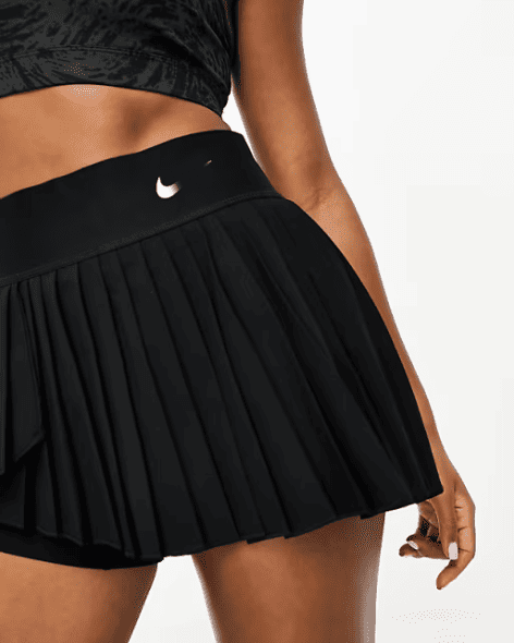 High-waisted black pleated tennis skirt showing the flattering flared fit,
perfect for professional padel performance.