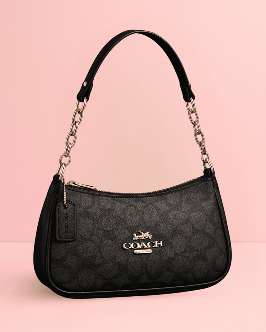 Sleek black monogram coach inspired Baguette Bag with gold chain handle and polished finish.