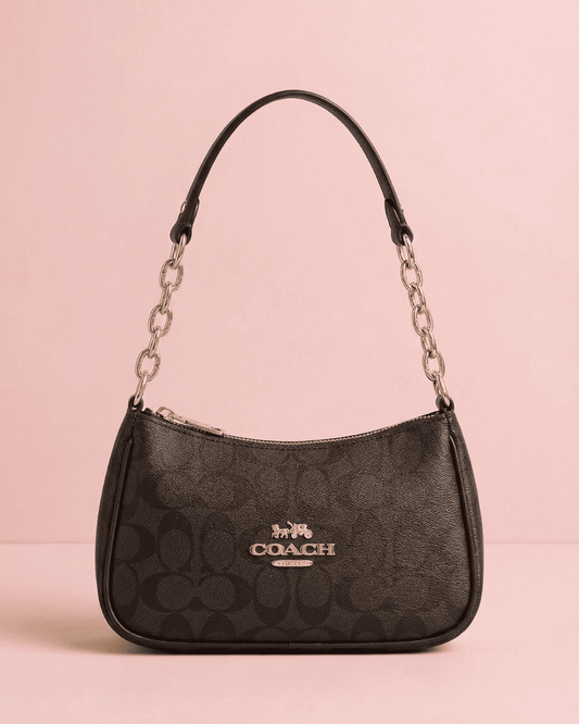 Classic dark brown monogram Coach inspired Baguette Bag with gold hardware and curved silhouette.