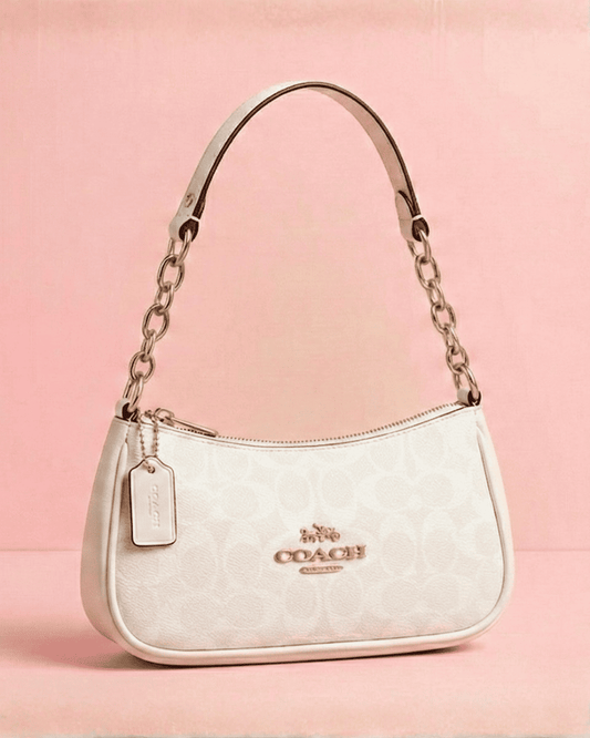 Elegant white monogram coach inspired Baguette Bag with gold chain detail and minimalist design.