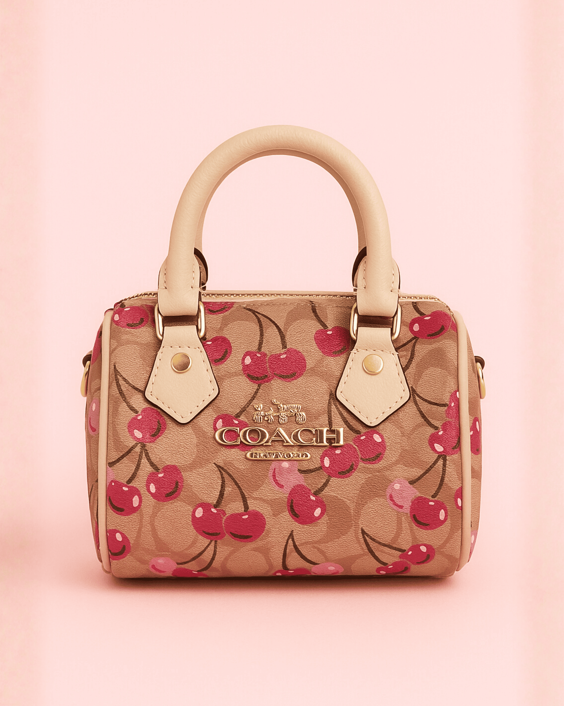 Beige monogram coach inspired mini bag with red cherry print and gold-tone hardware, aesthetic it-girl style.